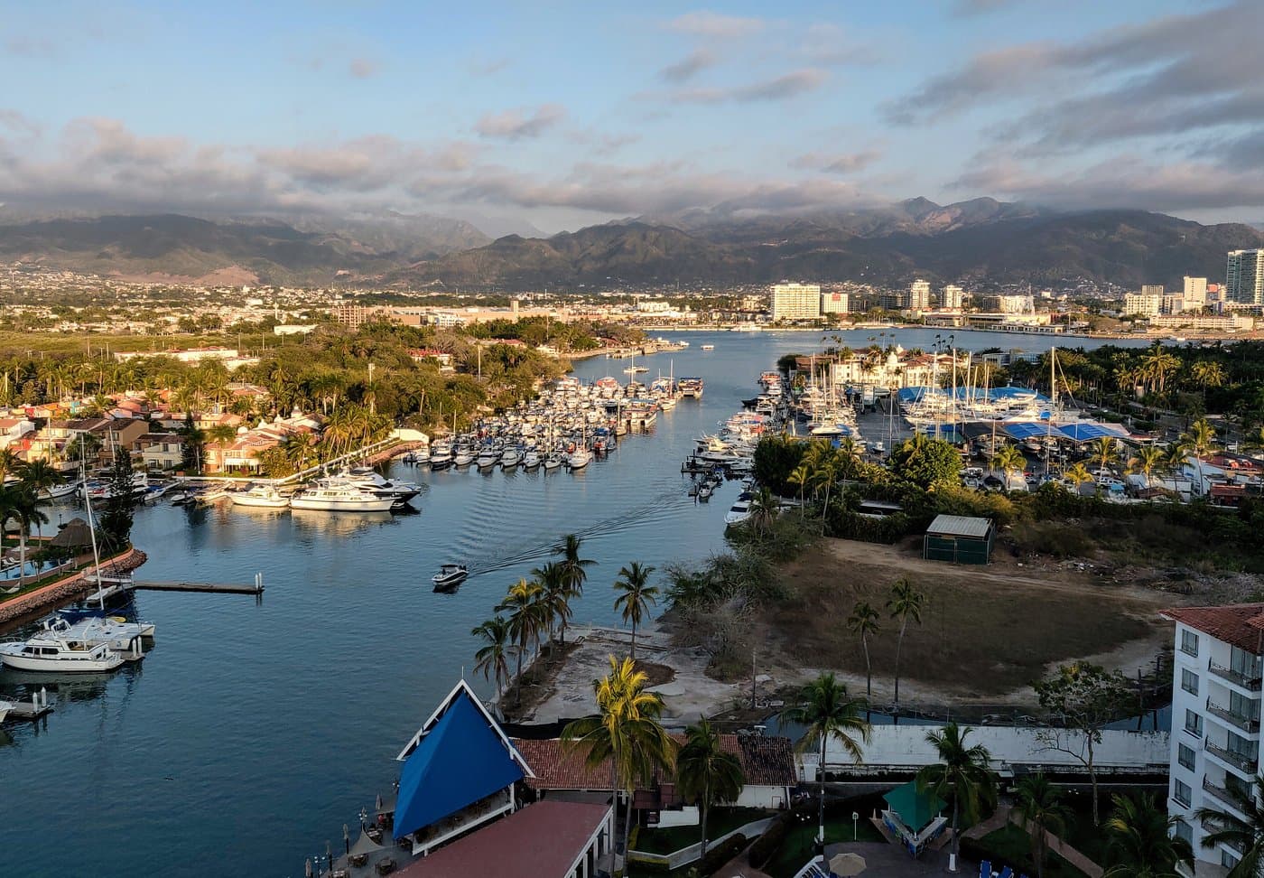 Marina Vallarta’s channel at golden hour, the Sierra Madre behind it.
